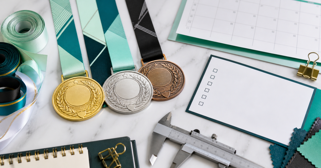 Finisher medals and award medals arranged with planning checklist